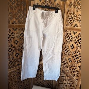 White mid rise wide leg jeans with brown thread detailing along the seams